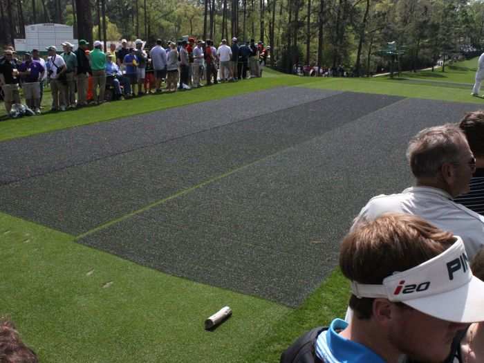 To protect the par 3 tee boxes, they lay down this black mesh netting.