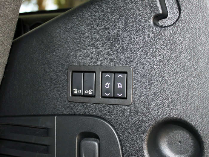 The tailgate can be opened by waving your foot near the back of the car, and there are buttons to fold down the second and third row seats.