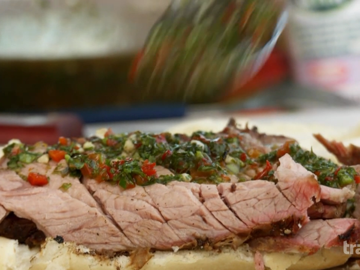 At the same stand, he orders a grilled pork sandwich loaded with chimichurri sauce, garlic, parsley, oregano, olive oil and touch of vinegar.