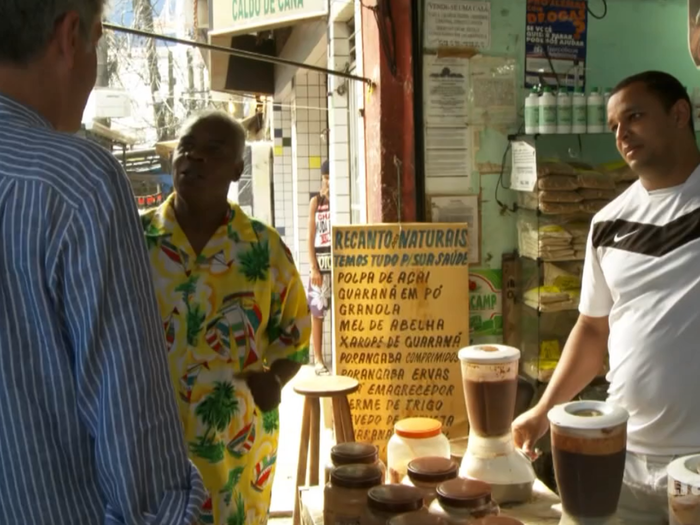 His local tour guide, Paulo Amendoim, first takes him to drink a mysterious brown substance.