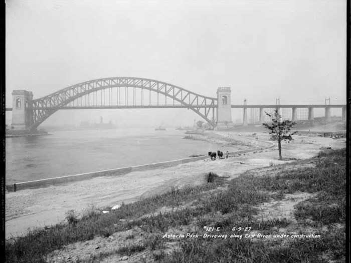 The construction of Shore Boulevard in Astoria Park with Hell Gate Bridge in the background, June 9, 1927.