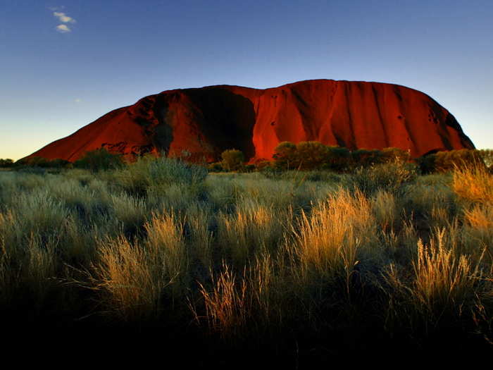 The sun sets on Ayers Rock, one of Australia