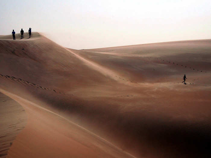 Tourists explore sand dunes in Africa
