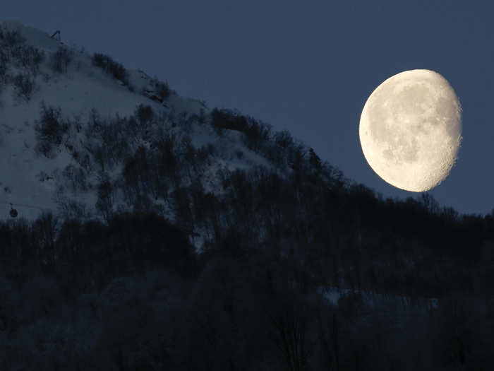 The moon is pictured above the mountains in Rosa Khutor in Russia during the 2014 Sochi Olympics.