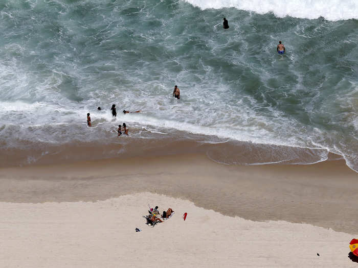 Residents and tourists relax at Copacabana beach in Rio de Janeiro.