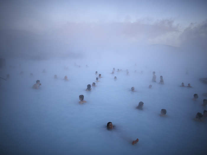 People relax in one of the Blue Lagoon hot springs in Iceland.