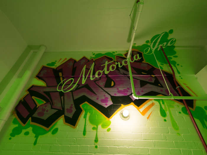 Colorful graffiti is splattered on the walls of the stairwell.