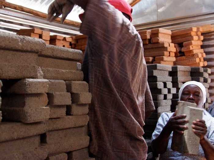Residents of Kibera make bricks for new properties as part of a community project.