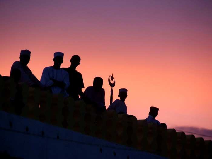 Men watch the nighttime celebrations of Maulidi from the roof of Lamu’s world-renowned mosque.