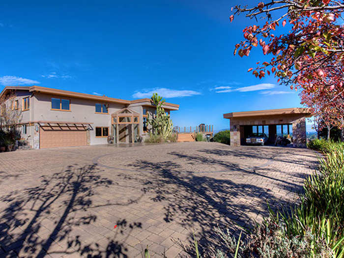 Inside the compound, a large courtyard and two garages provide plenty of space for cars.