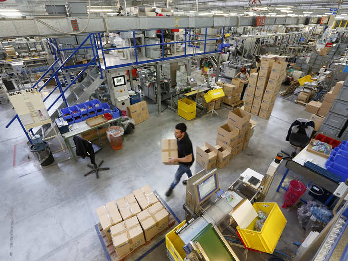 Employees work to package the toys together.