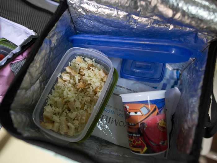 BUENOS AIRES, ARGENTINA: A lunch box containing rice with chicken Milanesa — chicken covered with egg and bread.