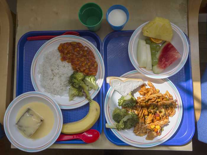 LONDON, ENGLAND: The meal on the right consists of pasta, fresh broccoli, slices of bread, and seasonal fresh fruit. The other option is vegetable chili with rice and fresh broccoli, sponge cake with custard, and a banana.