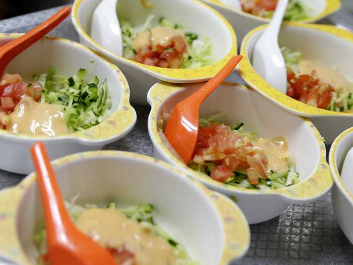 SINGAPORE: Bowls of salad are prepared by the school