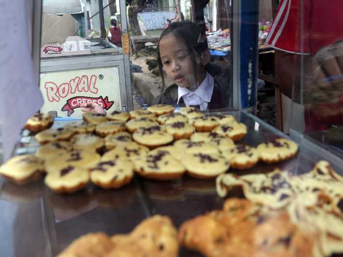 JAKARTA, INDONESIA: Students also buy pancakes on the street for the equivalent of one cent.