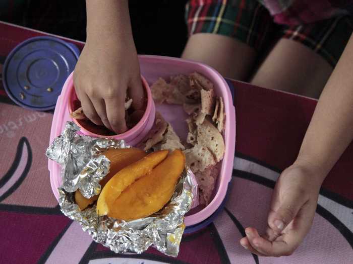 JAMMU, INDIA: This home-made lunch contains flatbread, a turnip dish, and mangoes.