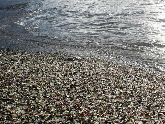 1. Glass Beach at MacKerricher State Park in northern California used to be a place where residents of Fort Bragg dumped their trash, including household appliances and even vehicles. In the decades since the state banned this practice and cleaned up the area of the larger debris, the waves turned the remaining glass into smooth fragments that litter the beach.