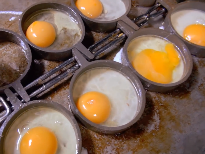 How long are cooked eggs held in hot boxes after they are prepared?