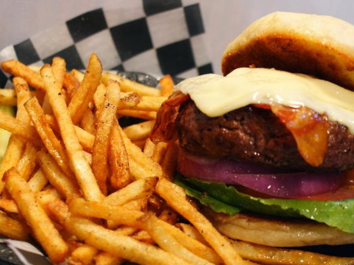 RHODE ISLAND: The Abbey in Providence is a little pub known for its burgers and beer. It has 14 different signature burgers, but the best is the "Hair-of-the-Dog-That-Bit-You" burger, a 10 oz burger smothered in sautéed onions and topped with a grilled sausage patty, fried egg, bacon, and American cheese.