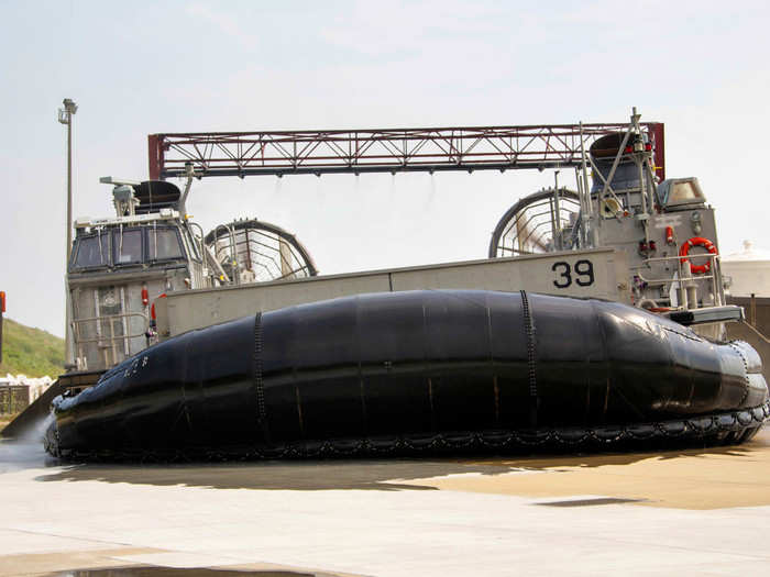 ... the pilot eases the LCAC out and lets it settle on one side over a separate drain to ensure no chemicals will flow out into the water.