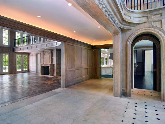 Upon entering the main house, a cove-lit hallway leads to the great room.