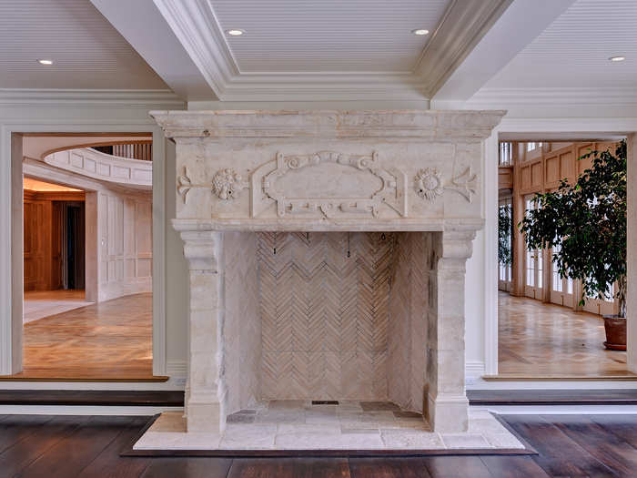 And this is a close-up of the "museum-quality 18th-century French Louis XV carved stone" fireplace in the family room.