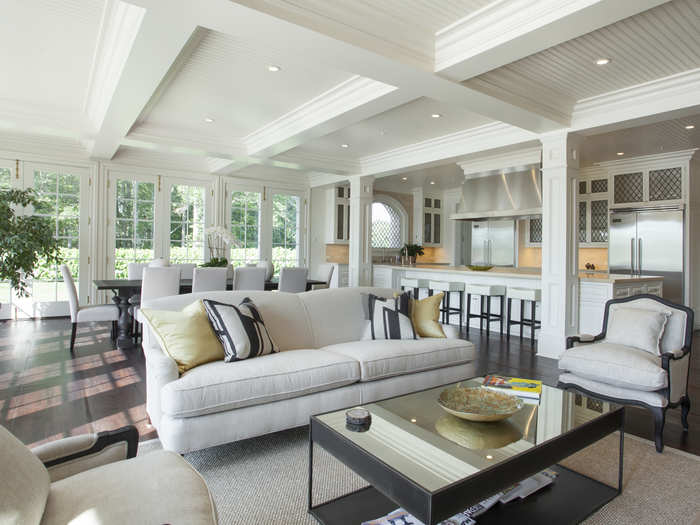 Here is a photo of the furnished kitchen/family room. The kitchen itself is equipped with a La Cornue stove, two dishwashers, two refrigerators, and custom cabinetry. Next to the kitchen is a second catering kitchen for entertaining.