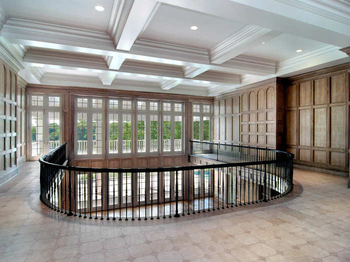 Upstairs, the second floor has a large gallery overlooking the living room and French doors leading to more porches.