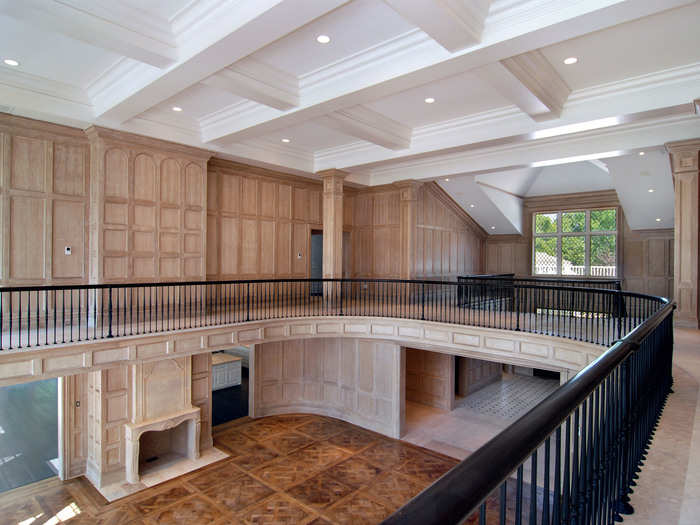 The staircase has custom iron railings specifically designed and cast for the house. The diamond-pane leaded windows in the back are made from hand-crafted glass.