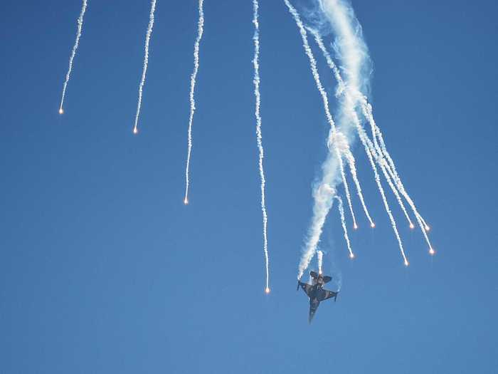 Here, the Turkish jet is in a dive while firing off its complement of flares.