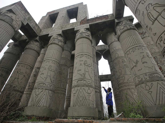 EGYPT: A traveler takes a photo of a replica of the Karnak Temple at the abandoned Wanguo park in Wuhan, Hubei province.