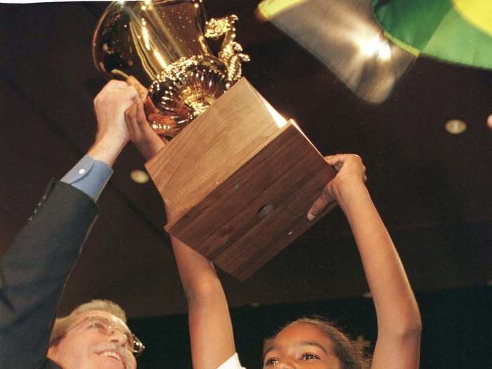 Jody-Anne Maxwell hoists the trophy above her after scoring the victory with "chiaroscurist" in 1998.