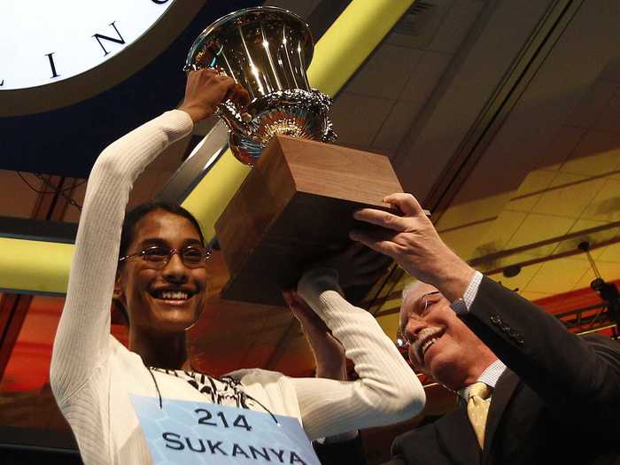 Sukanya Roy needs help to hold up the gleaming symbol of her victory in 2011. She won with "cymotrichous."