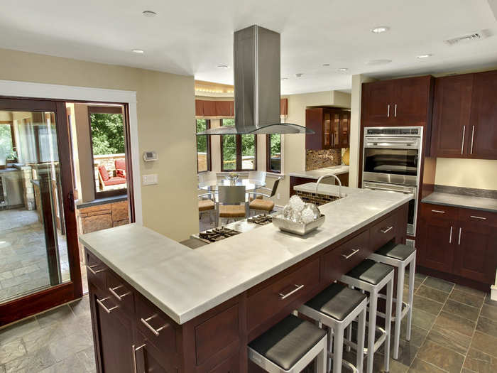 The kitchen has some beautiful dark wood cabinets. You