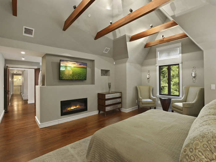 Up on the top floor, the master bedroom has high angled ceilings and a flat screen TV.