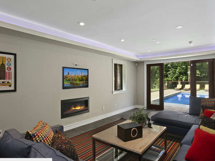 On the lower level, a living room opens on to the pool area. A wireless Sonos sound system plays music through this part of the house.