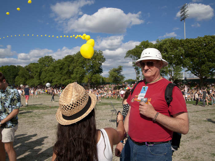 Balloon chains ring the festival grounds and are held in place by crew like Peter Jaquay. He even let passerby give holding the balloon chain a try.