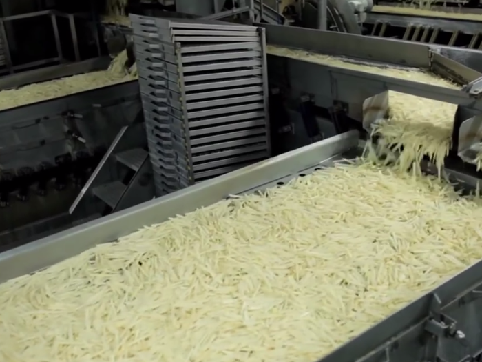 Now, the potatoes are sliced and ready to be blanched. The blanching process strips the natural sugars and keeps them from turning different colors.