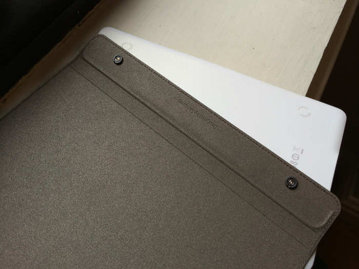 The Book Cover snaps onto the back of the Galaxy Tab S with those little buttons.