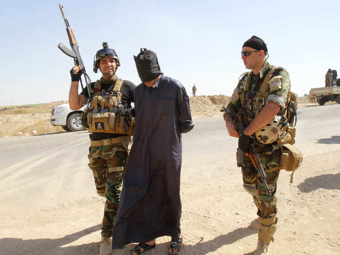 The Peshmerga have also turned into a de-facto police force in some places — Iraqi police abandoned their posts in Kirkuk, for instance. Here, Peshmerga forces detain a suspected ISIS militant.