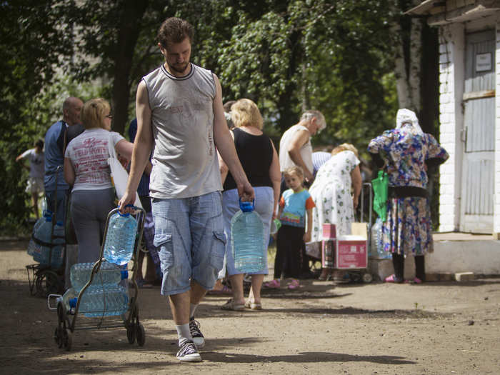 Many are forced to collect water from communal pumping stations.