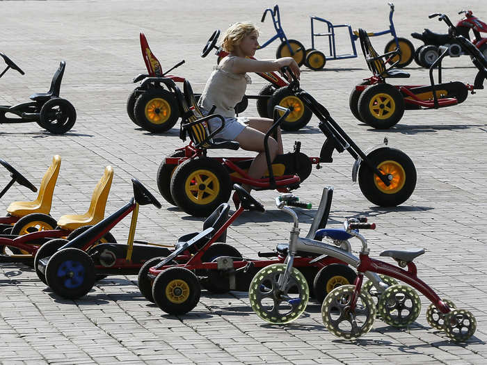 In central Donetsk, another woman waits to rent out pedal cars to whatever few interested customers she can find.