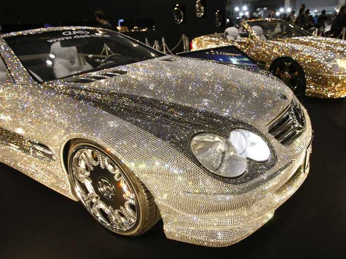 Two custom Mercedes-Benz SL600s, each wearing 300,000 Swarovski crystals, are displayed in Tokyo.