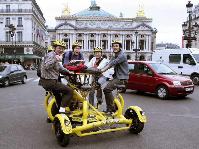 Up to 7 tourists can share one of these bikes (dubbed the "Velovisit") to cruise around Paris. The 7 seats face each other so riders can chat, while one person must be responsible for holding the handlebars and braking.