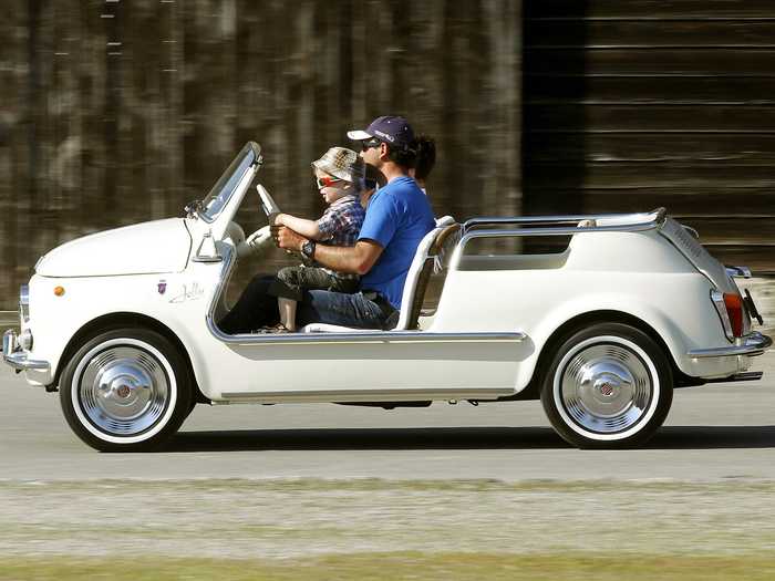 Two men drive a vintage Fiat 500 in Zug, Switzerland.