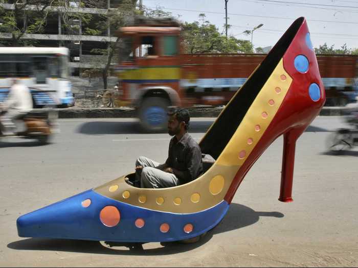 One lucky guy test-drives a high heel-shaped car in southern India.