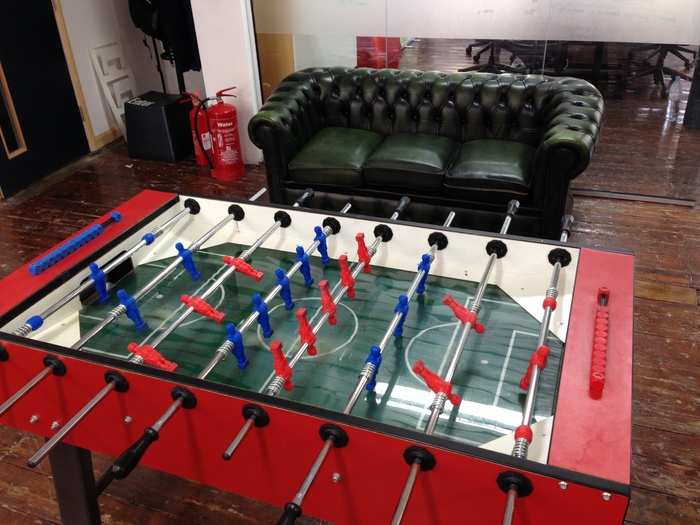 Downstairs in a communal area there is a table football game. (It