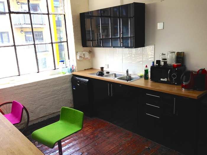 Another kitchen area with a fully stocked bar.