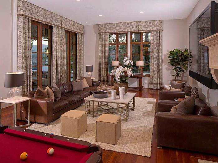 This living room has a pool table and plenty of seating.