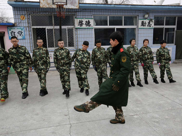 A former military instructor teaches students close-order drills at Qide. Most of the teenagers are there at the request of their parents.